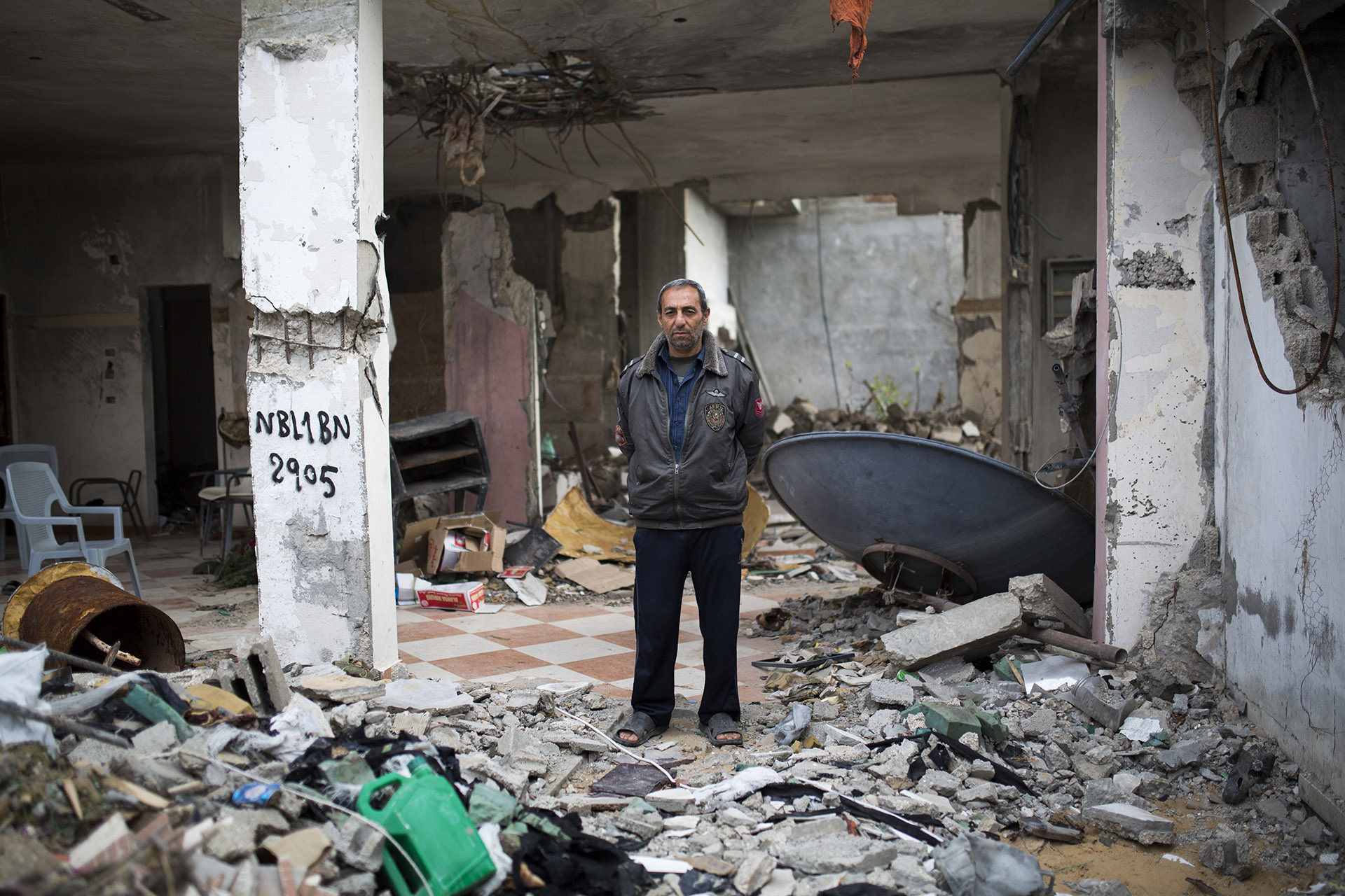 Abdelhadi standing in the rubble of Majdalawi's bombed house. “We had such a beautiful, solid three-story home”, he says. 
