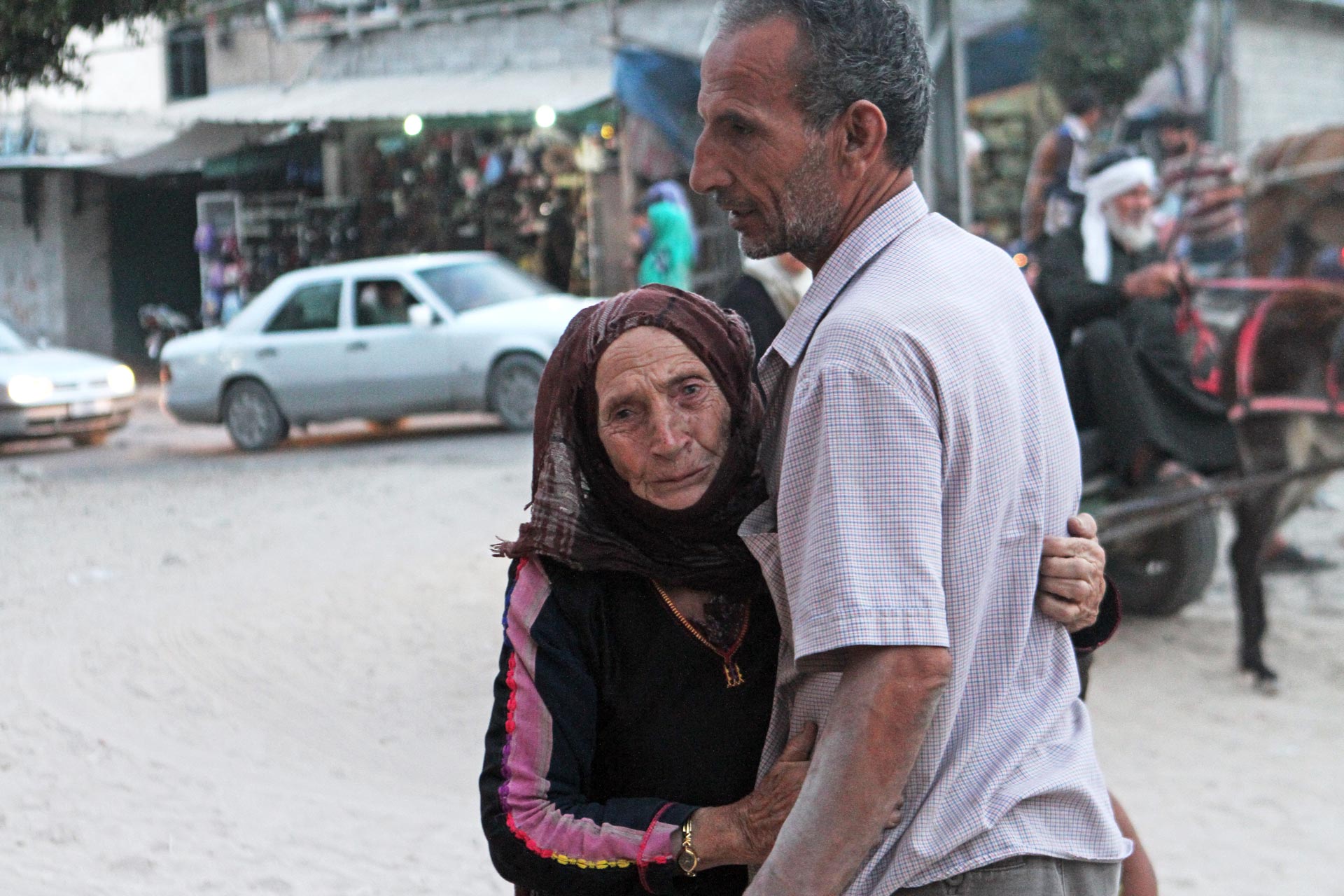Fatma al-Kilani, always searching or waiting for her son Ibrahim to return home. Here, she embraces her eldest, Saleh.
