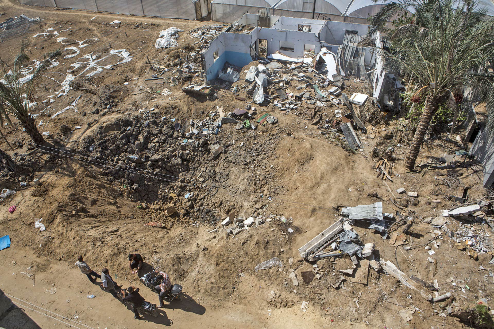 Seven trucks of sand were not enough to fill the bombed-out crater where Rafat's house once stood.
